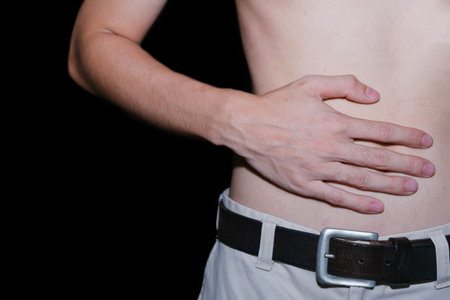 Close-up a young man suffering from stomach pain.copy space.の写真素材