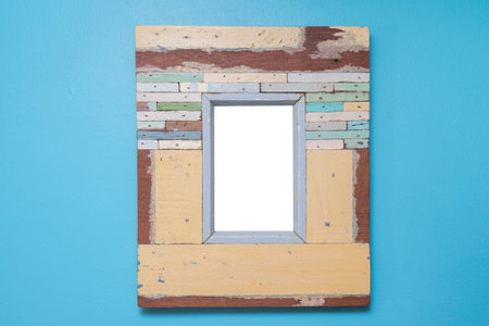 Empty vintage frame isolated on blue cement wall.の写真素材