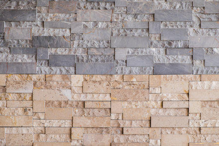 Haft grey and brown modern stone wall background/texture.の写真素材