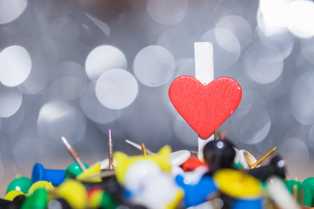 Alone heart paper clip standing on many pin. Step across obstacles in life for our love....
