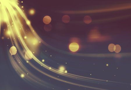 Gold sparkle twirl and glitter radial rays twinkled lights bokeh beautiful abstract background.Vintage or retro tone.の写真素材