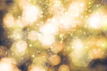 Gold glitter sparkles rays lights bokeh Festive Elegant abstract background. Vintage or retro tone.の写真素材