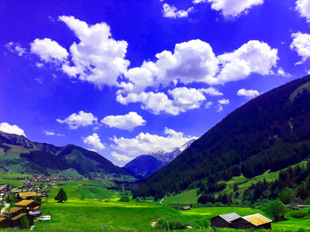 beautiful landscape of a mountain valley with a village surrounded by high cliffsの写真素材