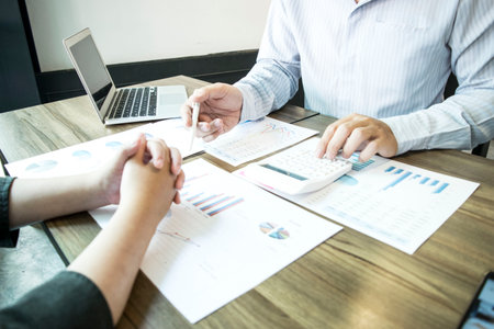 Accountants are examining the company's finances to prepare for expansion into East Asia.の写真素材