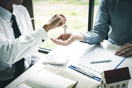Accountants are checking the homeowner's finances to ensure there is a deposit.の写真素材