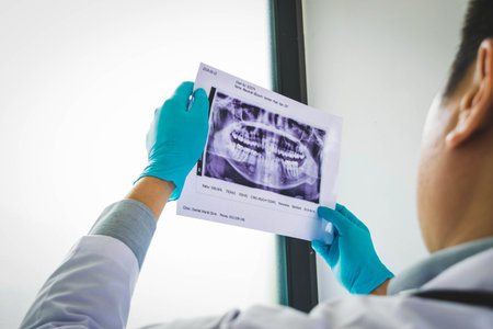 The dentist examining the teeth of the patient found that his teeth have improved.の写真素材