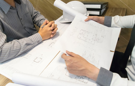 A young man, an engineer, had a meeting to prepare the construction work.の写真素材