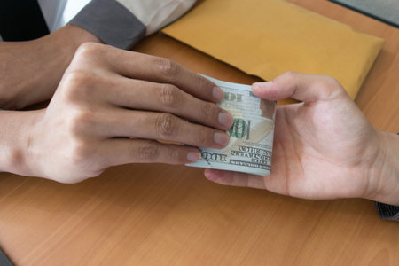 Company employees have been corrupt by bringing money to the company's human resources department. To allow him to be promoted to managerの写真素材