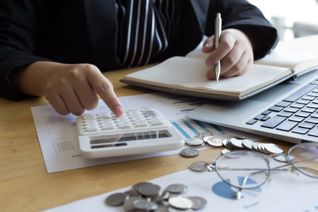 The young accountant is checking the money of a reputable national financial organization in a...