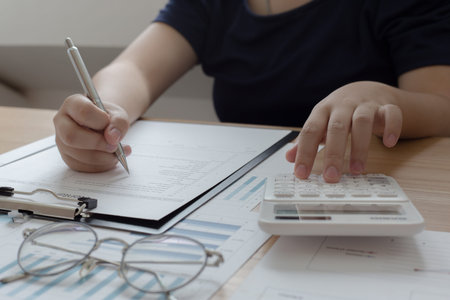 The young accountant is checking the money of a reputable national financial organization in a...