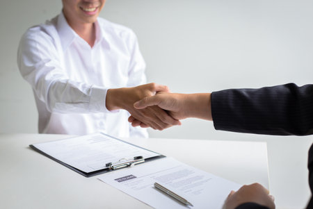 Business success, portraying male businessmen working with women to show their willingness to join together, Handshake to connect work relationships.の写真素材