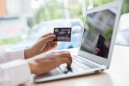 her are buying products online by paying via credit cards, online shopping and technology conceptの写真素材