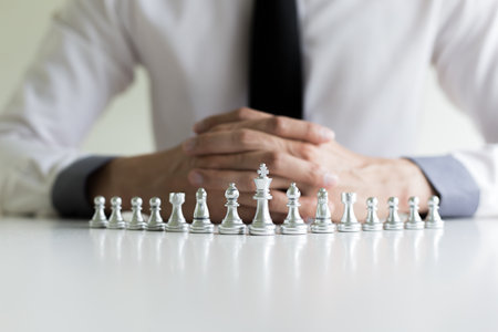 A young business man is playing chess, business strategy to be successfulの写真素材