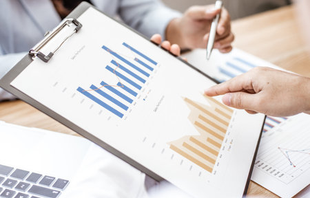 Meeting a team of businessmen, Executives and accountants meeting about the company's revenue graph...