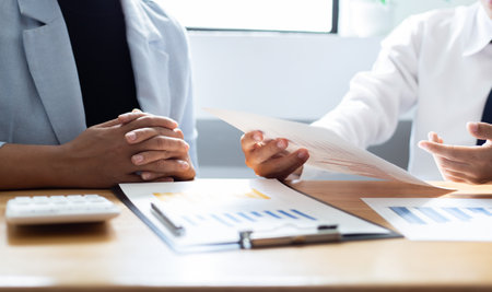 Meeting a team of businessmen, Executives and accountants meeting about the company's revenue graph in the office with laptops and calculators, Finance conceptの写真素材