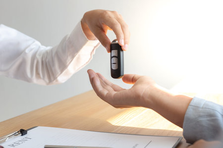 The car salesman handed the keys to the customer who passed the car purchase loan conditions ,Car...
