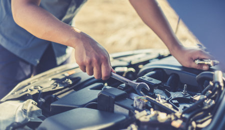 Car mechanic has checked the condition of the engine in wrench, Car repair service concept.