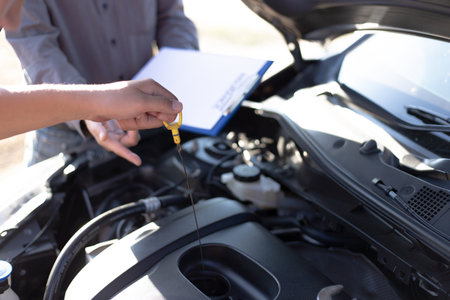Car mechanic has checked the condition of the engine in wrench, Car repair service concept.の写真素材