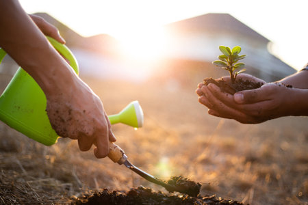 Two men are planting trees and watering them to help increase oxygen in the air, Save world save life and Plant a tree concept.の写真素材
