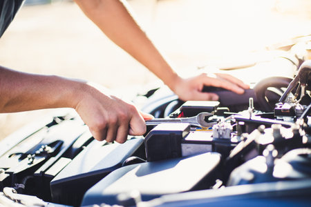 Car mechanic has checked the condition of the engine in wrench, Car repair service concept.