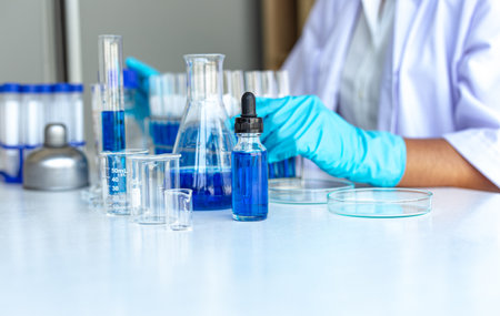 Scientists are carrying blue chemical test tubes to prepare for the determination of chemical composition and biological mass in a scientific laboratory, Scientists and research in the lab Concept.の写真素材