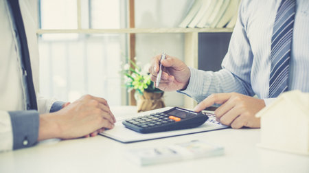 Agents, brokers or real estate business professionals advise clients who want to take out home insurance and offer terms and conditions for approval, Finance or Accounting and Insurance Conceptの写真素材