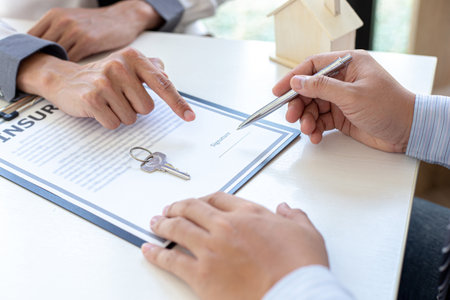 Home insurance agents offer terms and conditions to clients and get approval, home purchase and insurance contracts, Real estate investment of Conceptの写真素材