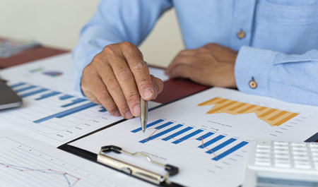 Businessmen analyze market data and calculate the cost of buying-selling products for a client's...