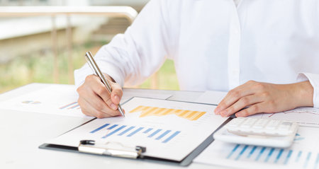 Financial business people are analyzing and examining Revenue - expense of real estate of the...