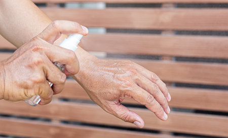 Man uses a spray of alcohol to get rid of bacteria and viruses, Inhibition and prevention of Covid-19 virus infection using 70 percent alcohol, protect virus concept.の写真素材