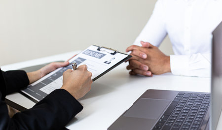 Employer or HR department is reading the resume and interviewing the ability of new employees, Employer is selecting job applicants, Employment and Recruitment Concept.の写真素材