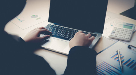 The world of technology and internet communication, Financial professionals use laptop to calculate...