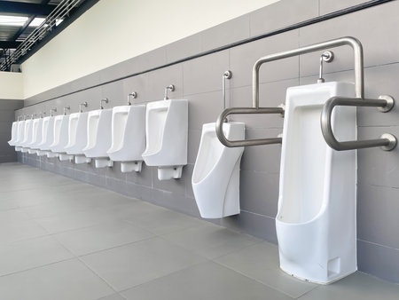 Men's white urinals design, Close up row of outdoor urinals men public toilet, Urinal concept.の写真素材