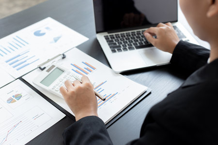 Accounting businessmen are calculating income-expenditure and analyzing real estate investment data, Financial and tax systems concept.の写真素材