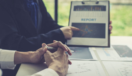 Accountants and financiers are brainstorming the analysis of revenue performance with stock graphs at meetings, Analysis of real estate investment and income tax data concept.の写真素材