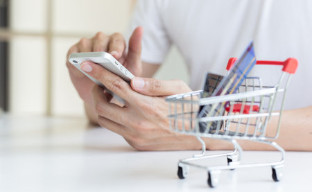 Men use smart phone to register online purchases using credit card payments, Convenience in the world of technology and the internet, Shopping online and banking online concept.の写真素材