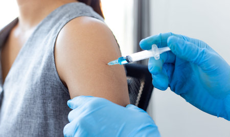 Vaccination of patients, Doctor provided a vaccine with a syringe against a new strain of  virus or...