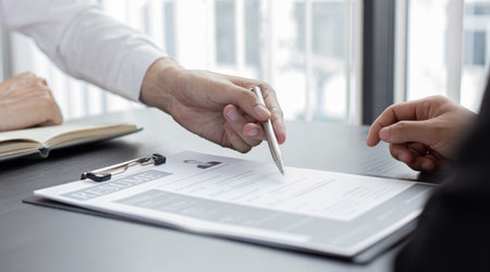 HR head is reading the resume and information about the candidate's history, Field employers are interviewing job applicants and negotiating agreements, Recruitment and job applications concept.の写真素材