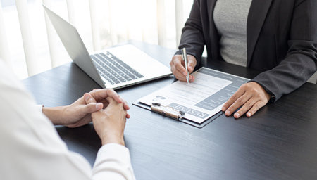 HR head is reading the resume and information about the candidate's history, Field employers are interviewing job applicants and negotiating agreements, Recruitment and job applications concept.の写真素材
