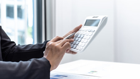 Businesswomen are calculating finances and analyzing market data with graphs and laptops at work, Business Financing Accounting Banking and tax system Concept.の写真素材