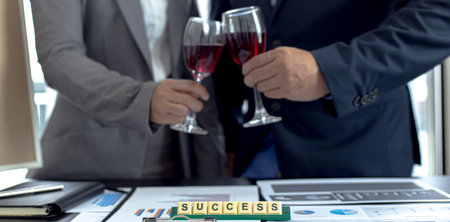 Both businessmen drink White to celebrate their financial and business success, Congratulate and celebrate concept.の写真素材