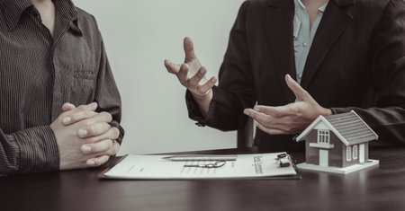 Real estate agent or sales manager has offered home sales and explained the terms of signing the house purchase contract and free home insurance, Finance and after-sales service concept.の写真素材