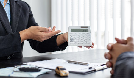 Car dealers or managers have offered special prices and conditions for car purchases with insurance. Service and offering or financial banking concept.の写真素材