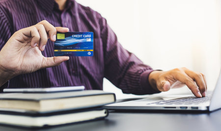 Businessmen use laptop to register online purchases using credit card payments, Convenience in the world of technology and the internet, Shopping online and banking online concept.の写真素材