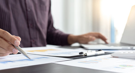 Independent financial businessmen calculate the client's annual income and analyze the market in-depth with office graphs, Income Tax Management and Financial Accounting concept.の写真素材