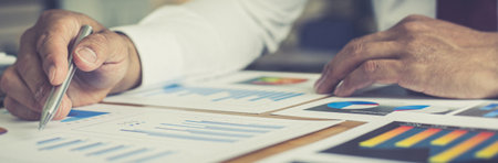 Accounting businessman are calculating income-expenditure and analyzing real estate investment data, Dedicated to the progress and growth of the company, Financial and tax systems concept.の写真素材