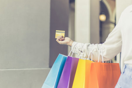 Young Asian women happily carry colorful shopping bags to shop in the mall or shopping center, Sale day, Happy shopping concept.の写真素材