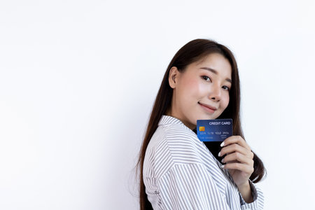 Young Asian business woman holding a credit card and smiling happily, Credit card purchases, Technology era concept.の写真素材