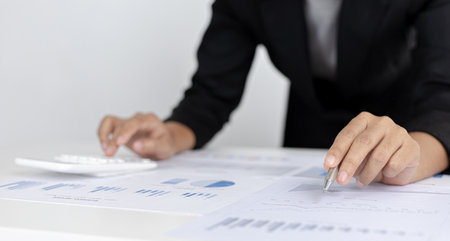 Accounting businessmen are calculating income-expenditure and analyzing real estate investment data, Dedicated to the progress and growth of the company, Financial and tax systems concept.の写真素材