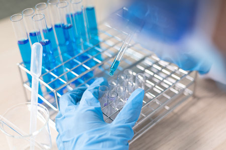 Scientists are carrying blue chemical test tubes to prepare for the determination of chemical...